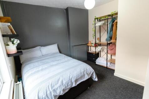 This inviting double bedroom features a cozy at...