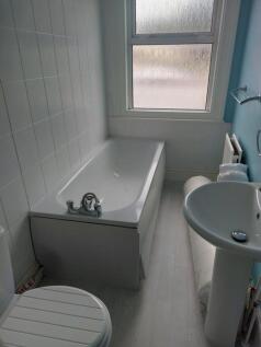 Bright and functional bathroom featuring a spac...
