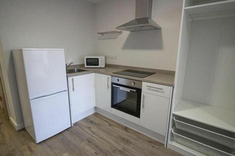 Modern kitchen featuring sleek cabinetry, ample...