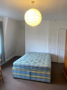 A neat double bedroom featuring a comfortable d...