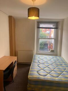 A neat double bedroom featuring a comfortable m...