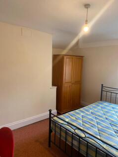 A tidy double bedroom featuring a metal framed ...