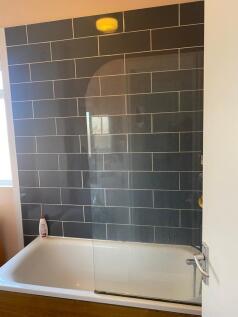 A modern bathroom featuring a stylish bath and ...