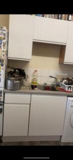 A cozy kitchen space featuring essential applia...