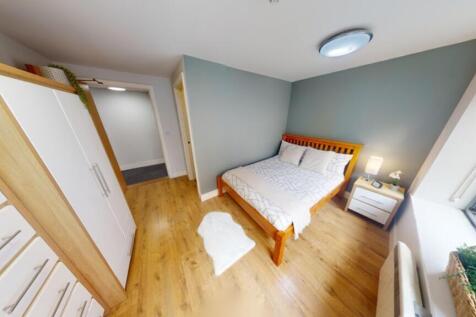 A bright and inviting double bedroom with moder...