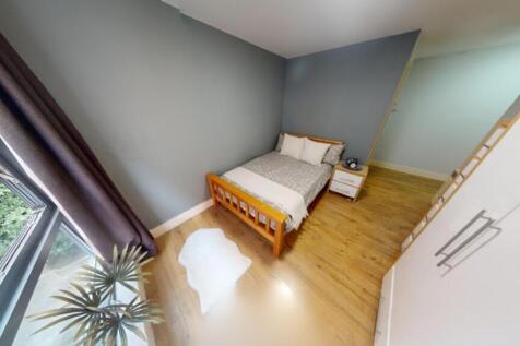 A bright and cozy double bedroom with modern de...