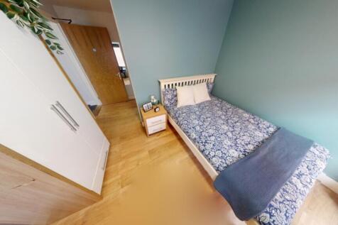 A cozy and clean single bedroom with a stylish ...