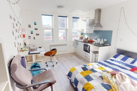 This vibrant double bedroom features a cozy lay...