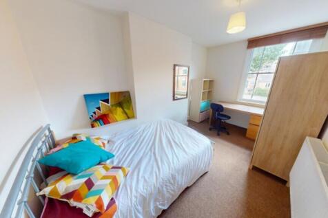 A bright and inviting double bedroom with cozy ...