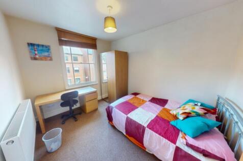 A bright and inviting double bedroom featuring ...