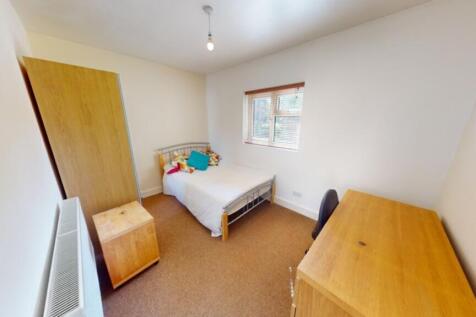 A bright and tidy double bedroom featuring ampl...