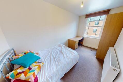 A bright and inviting double bedroom featuring ...