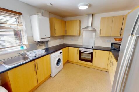 A spacious and well-maintained kitchen featurin...