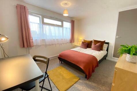 This inviting double bedroom features a cozy be...