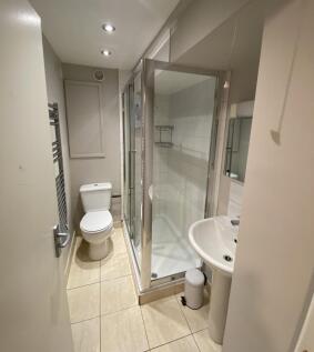 Bright and modern bathroom featuring a fully en...