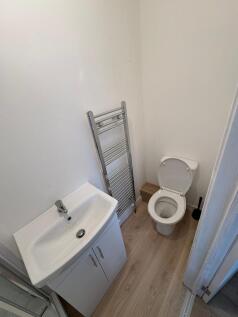 This modern single toilet features a sleek desi...