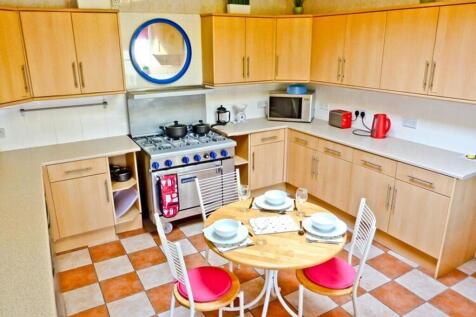 A bright and tidy kitchen featuring modern appl...
