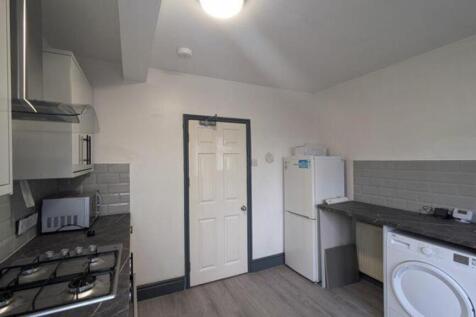 A bright and modern kitchenette with ample spac...