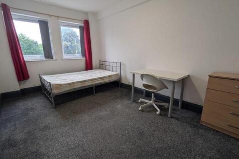 A spacious and well-lit double bedroom, featuri...