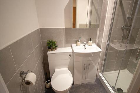 This modern bathroom features a sleek shower, s...