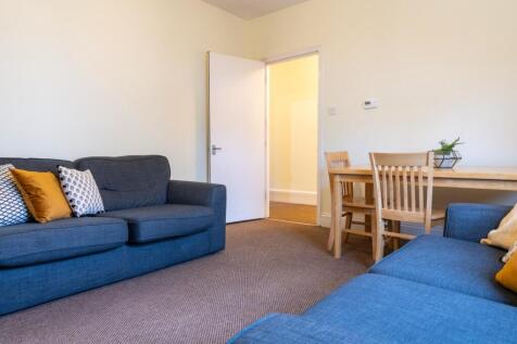 A bright and inviting living room featuring com...