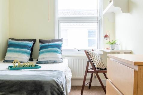 A beautifully styled double bedroom featuring s...