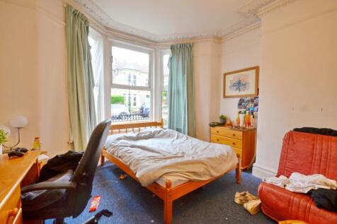 This inviting double bedroom features large win...