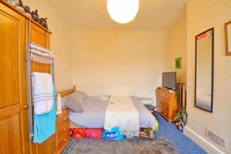 This cozy double bedroom features a comfortable...