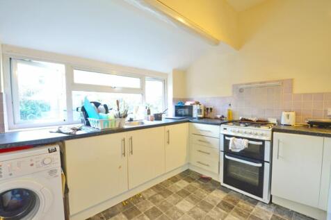 This well-lit kitchen features modern appliance...