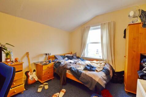 Cozy double bedroom featuring ample natural lig...