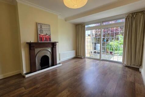 A bright and inviting living room featuring lar...