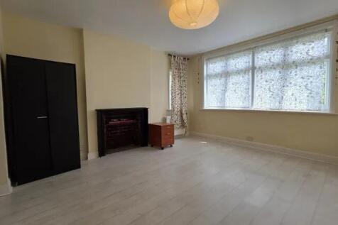 Spacious master bedroom featuring a large windo...
