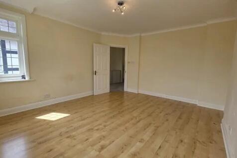 Bright and spacious living room with warm woode...
