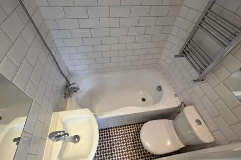A clean and modern bathroom suite featuring a b...