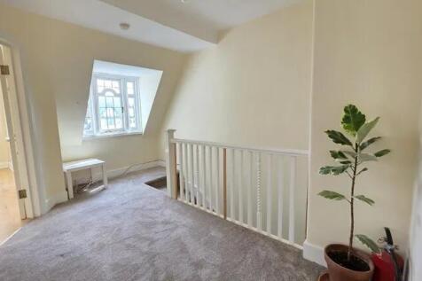 A bright and clean hallway area featuring a lar...