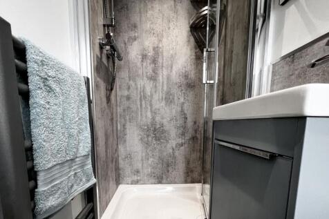 Modern bathroom featuring a sleek walk-in showe...