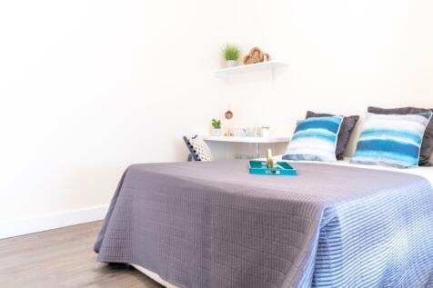 This inviting double bedroom features tasteful ...