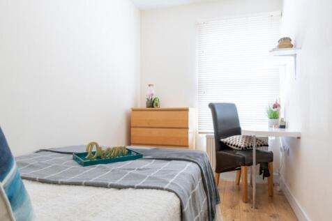 This stylish double bedroom features a comforta...