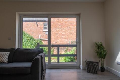 Bright and inviting living room with large wind...