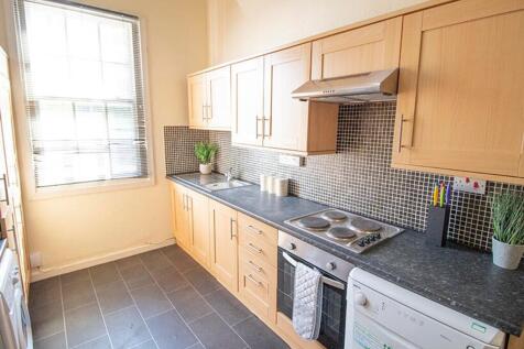 Bright and modern kitchen featuring sleek cabin...
