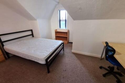 A cozy bedroom featuring a metal-framed single ...