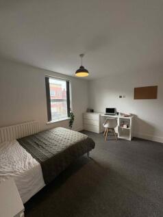 Bright and clean bedroom featuring a comfortabl...