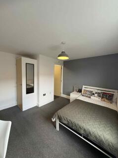 A well-maintained bedroom featuring a comfortab...