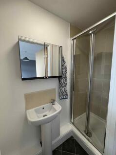 A clean and modern bathroom with a small sink, ...