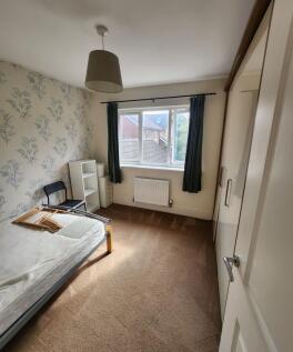A neat and bright single bedroom featuring a la...