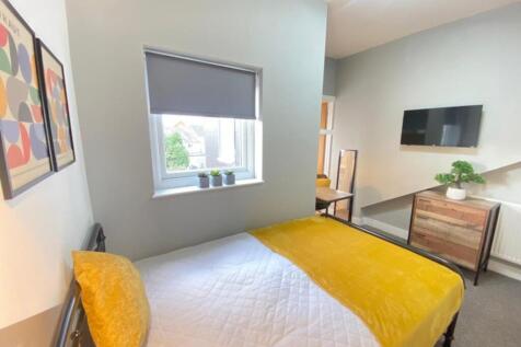 This inviting double bedroom features a cozy ye...