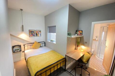 This inviting double bedroom features a cozy la...