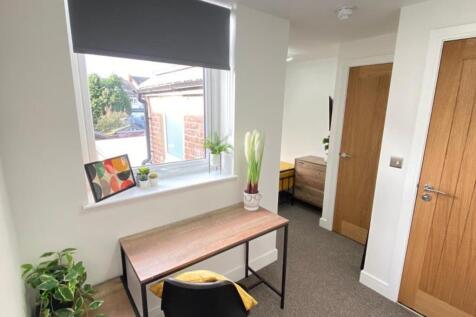 A bright and inviting communal workspace featur...