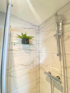 A modern bathroom featuring a stylish shower wi...