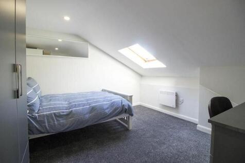 This inviting double bedroom features a cozy la...